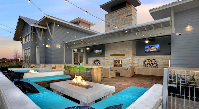 view of patio featuring an outdoor living space with a fireplace