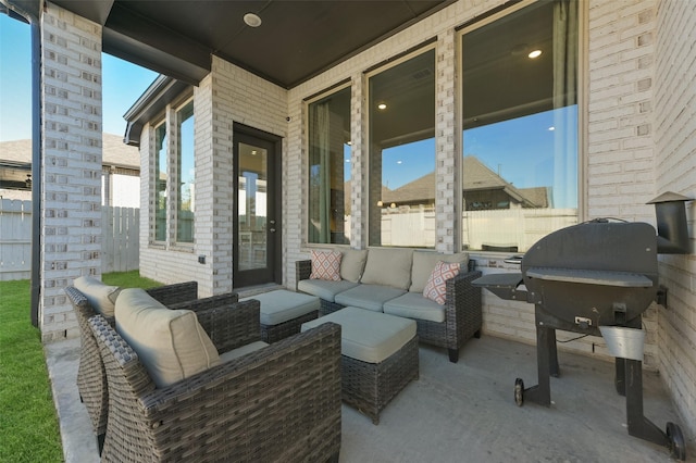 view of patio / terrace with area for grilling, outdoor lounge area, and fence