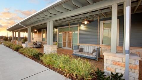 patio terrace at dusk with a porch and french doors