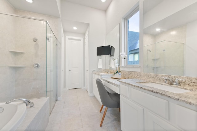 full bathroom featuring a stall shower, tile patterned flooring, vanity, a bath, and recessed lighting