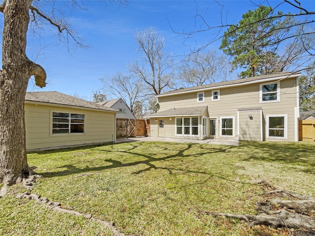 back of property featuring a yard, a patio area, and fence