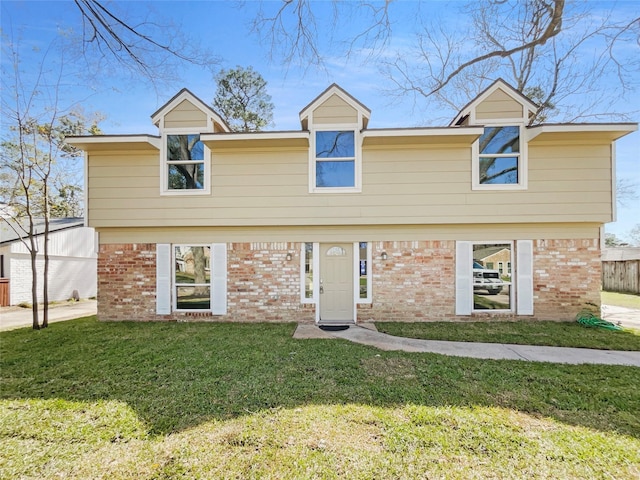 colonial home featuring brick siding and a front lawn