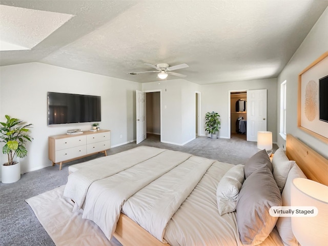 carpeted bedroom featuring baseboards, a ceiling fan, and a textured ceiling