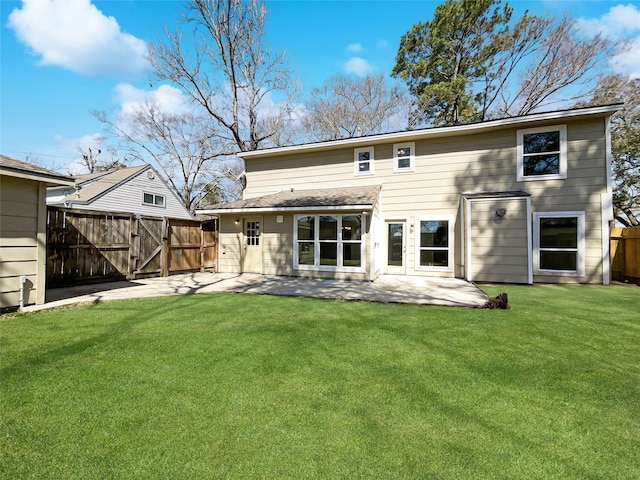 back of property featuring a patio area, a gate, fence, and a lawn