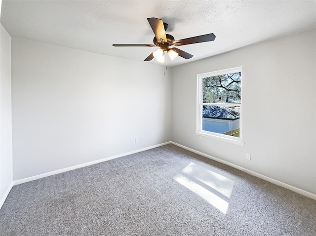 unfurnished room with a ceiling fan, a textured ceiling, baseboards, and carpet flooring