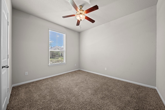 unfurnished room with carpet flooring, a ceiling fan, and baseboards