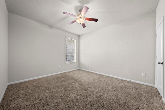 empty room with carpet, a ceiling fan, and baseboards