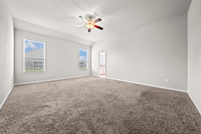 carpeted empty room featuring a ceiling fan and baseboards