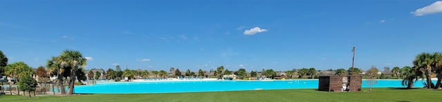 view of swimming pool featuring a lawn