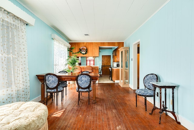 dining room featuring dark wood finished floors and baseboards