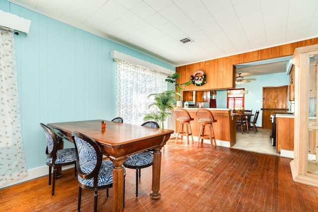 dining area featuring a ceiling fan, visible vents, and hardwood / wood-style flooring