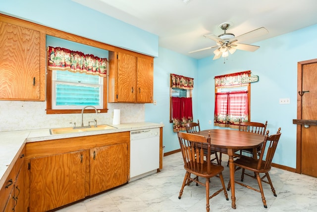 kitchen with tasteful backsplash, brown cabinetry, dishwasher, marble finish floor, and a sink