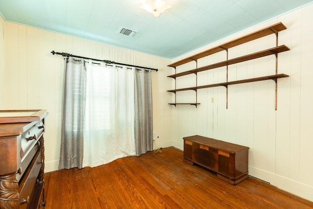 interior space with wood finished floors and visible vents