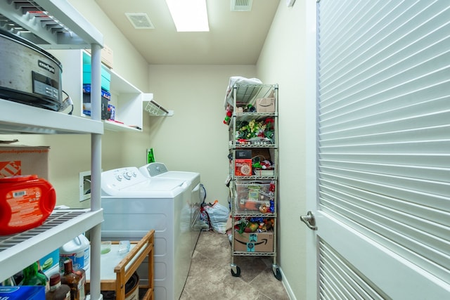 laundry room with laundry area, separate washer and dryer, and visible vents