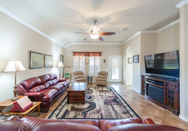 tiled living room featuring visible vents, baseboards, ceiling fan, ornamental molding, and a fireplace