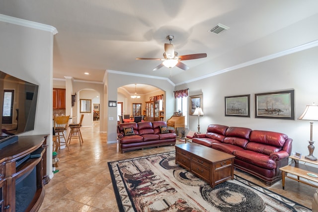 living area featuring visible vents, crown molding, baseboards, ceiling fan, and arched walkways