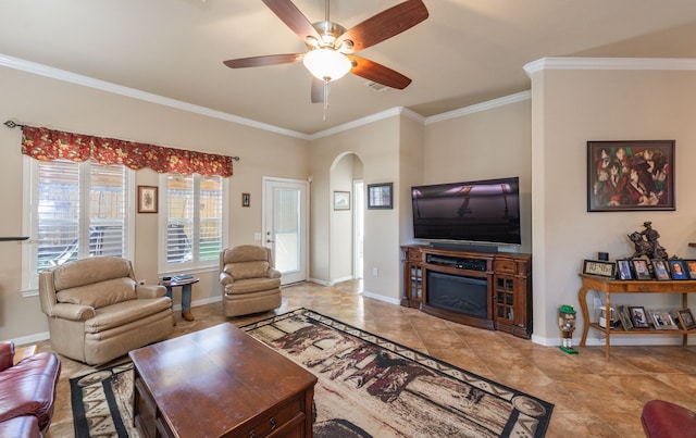 living area featuring visible vents, arched walkways, baseboards, and crown molding