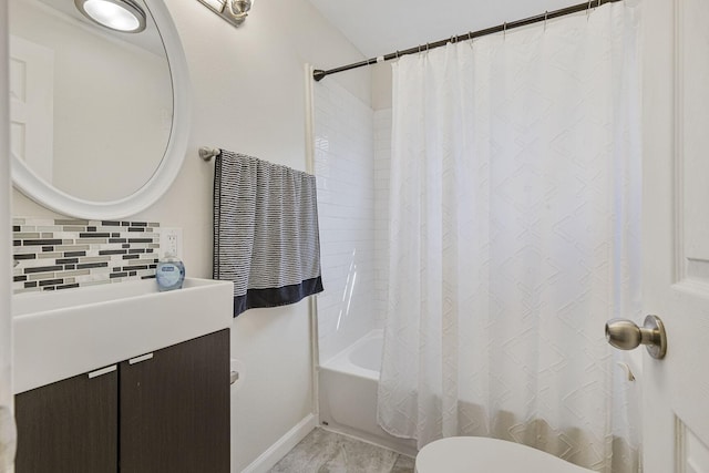 bathroom with tasteful backsplash, shower / bathtub combination with curtain, vanity, and toilet