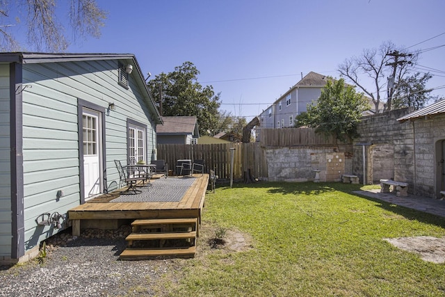 view of yard featuring fence and a wooden deck