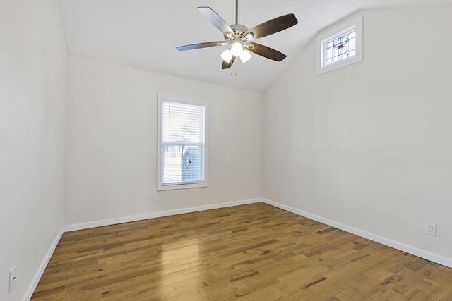 unfurnished room with lofted ceiling, ceiling fan, baseboards, and wood finished floors