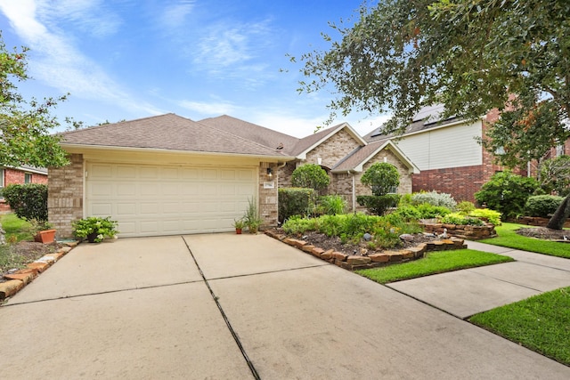 view of front of house featuring a garage, a shingled roof, concrete driveway, and brick siding