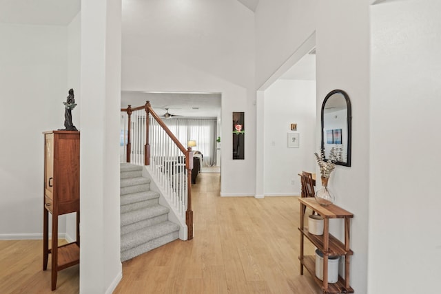 stairway with baseboards and wood finished floors