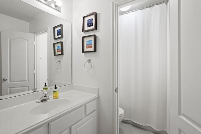 bathroom featuring toilet, curtained shower, tile patterned flooring, and vanity