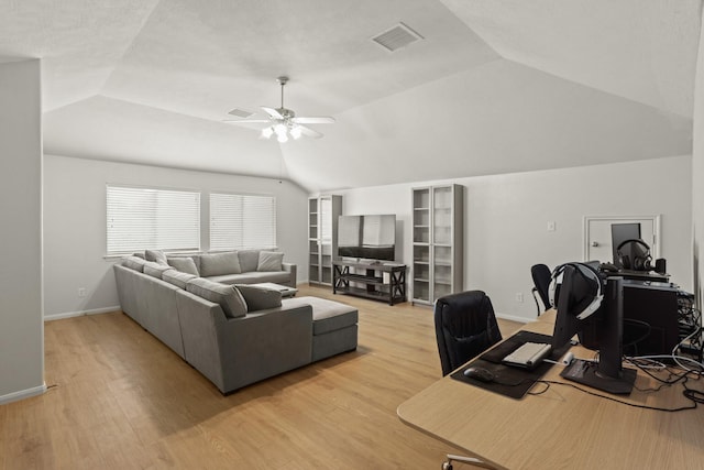 living area with visible vents, light wood finished floors, lofted ceiling, and a ceiling fan