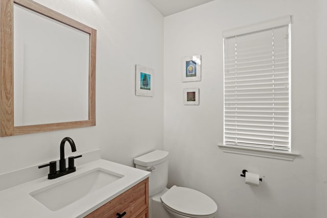 half bathroom featuring toilet and vanity