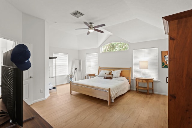 bedroom with visible vents, light wood-style flooring, a ceiling fan, vaulted ceiling, and baseboards