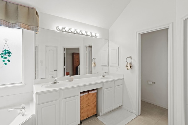 bathroom featuring lofted ceiling, double vanity, tile patterned flooring, and a sink