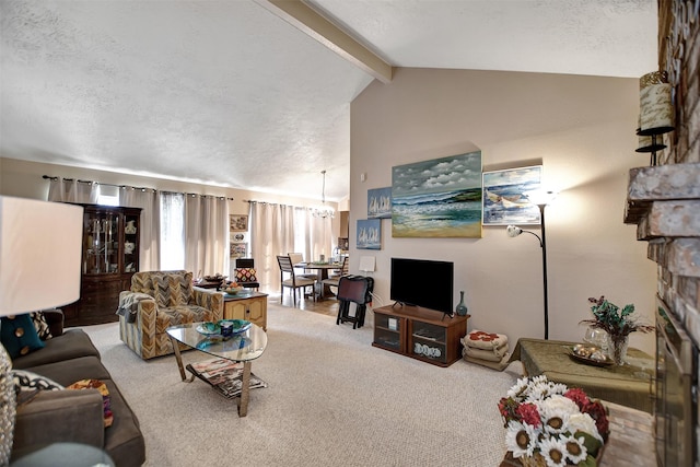 carpeted living area with a textured ceiling, high vaulted ceiling, a notable chandelier, a fireplace, and beamed ceiling