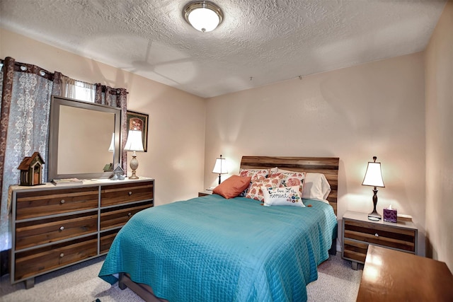 bedroom with a textured ceiling and carpet