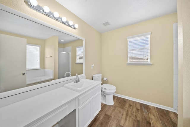 full bath featuring visible vents, baseboards, toilet, wood finished floors, and a shower stall