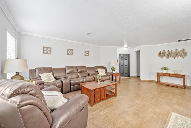 living room with a textured ceiling, visible vents, baseboards, light wood finished floors, and crown molding