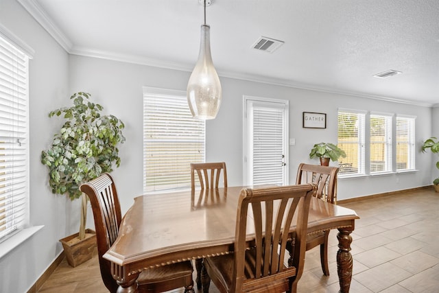 dining area featuring baseboards, visible vents, and ornamental molding