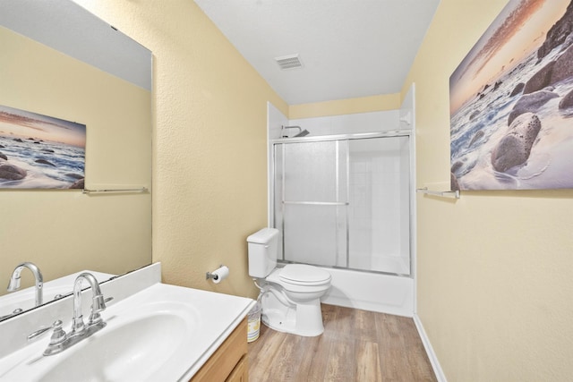 bathroom featuring baseboards, visible vents, toilet, wood finished floors, and vanity