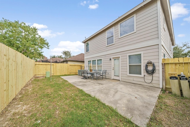 back of house with a patio area, a fenced backyard, and a lawn