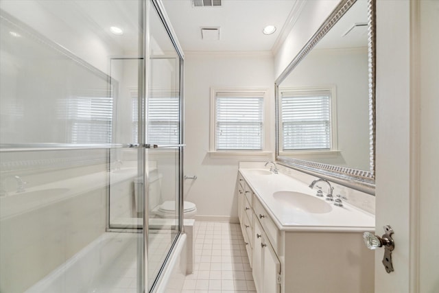 full bath featuring a shower with door, double vanity, ornamental molding, a sink, and tile patterned floors