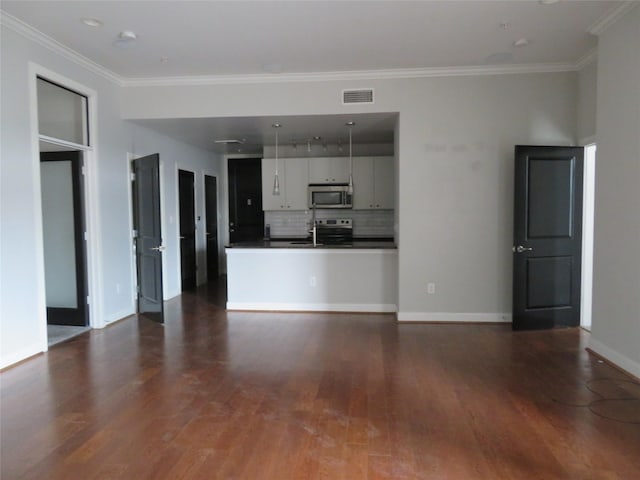 unfurnished living room featuring visible vents, dark wood-type flooring, and ornamental molding