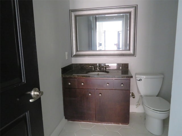 300 St Joseph Pkwy Unit 311, Houston, TX 77002 - bathroom featuring vanity, tile patterned flooring, baseboards, and toilet