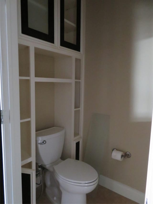 300 St Joseph Pkwy Unit 311, Houston, TX 77002 - bathroom featuring tile patterned floors, baseboards, and toilet