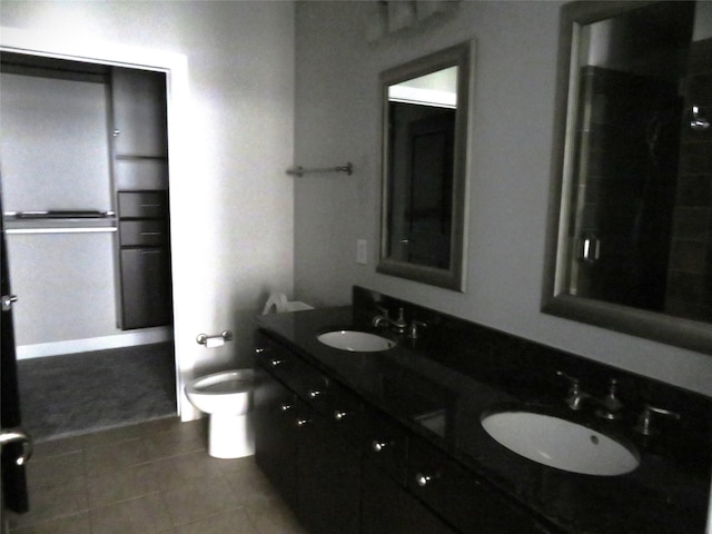 300 St Joseph Pkwy Unit 311, Houston, TX 77002 - full bath with tile patterned flooring, a sink, double vanity, and toilet