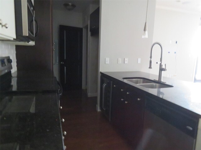 300 St Joseph Pkwy Unit 311, Houston, TX 77002 - kitchen featuring stainless steel microwave, electric range oven, dark wood-style flooring, and a sink
