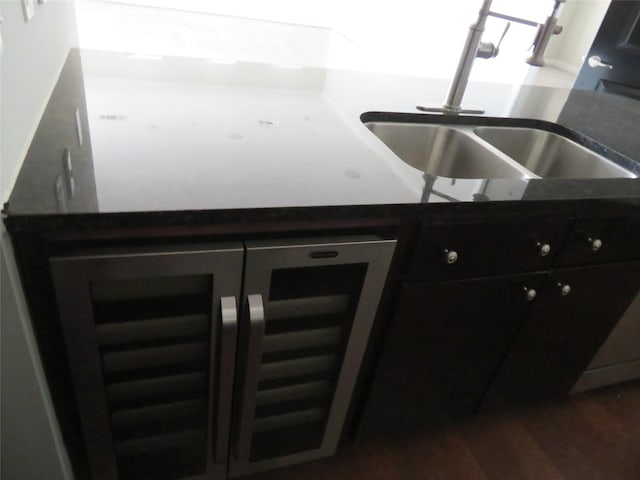 300 St Joseph Pkwy Unit 311, Houston, TX 77002 - interior space with dark countertops, wine cooler, a sink, and dark wood-type flooring