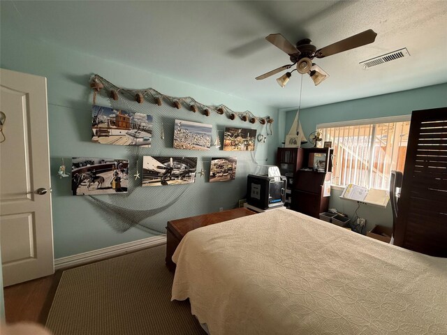 bedroom featuring ceiling fan and visible vents