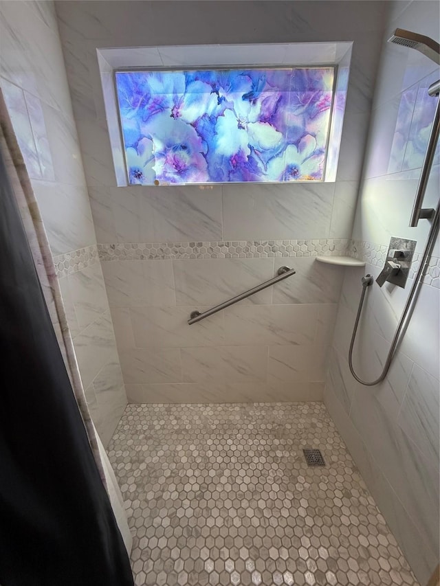 full bath featuring a tile shower