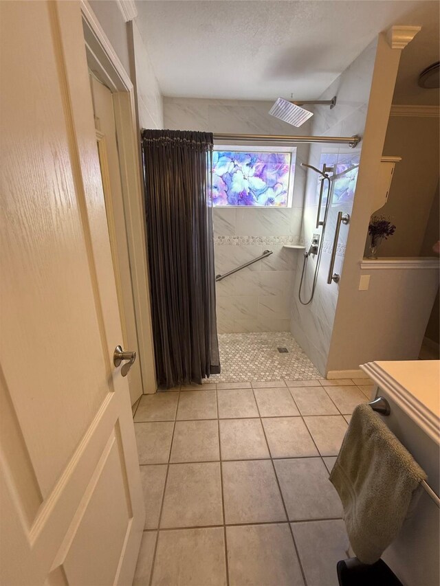 bathroom with visible vents, a tile shower, and tile patterned floors