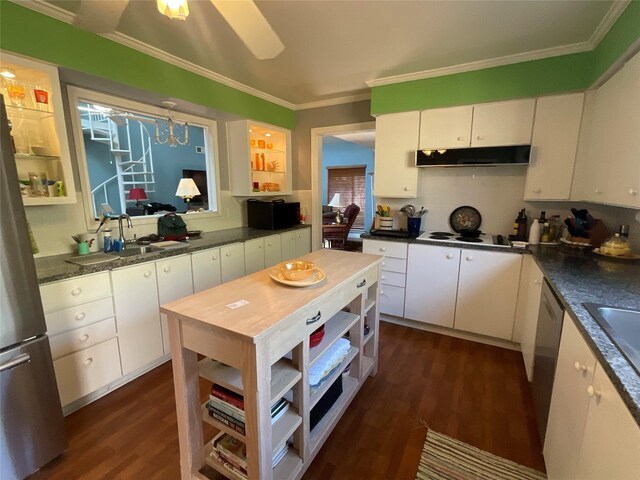 kitchen featuring under cabinet range hood, dark wood-style flooring, white cabinets, appliances with stainless steel finishes, and crown molding