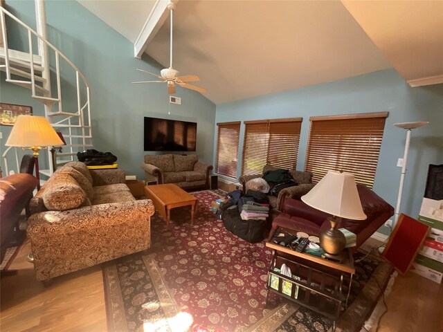 living area featuring visible vents, ceiling fan, stairway, wood finished floors, and high vaulted ceiling